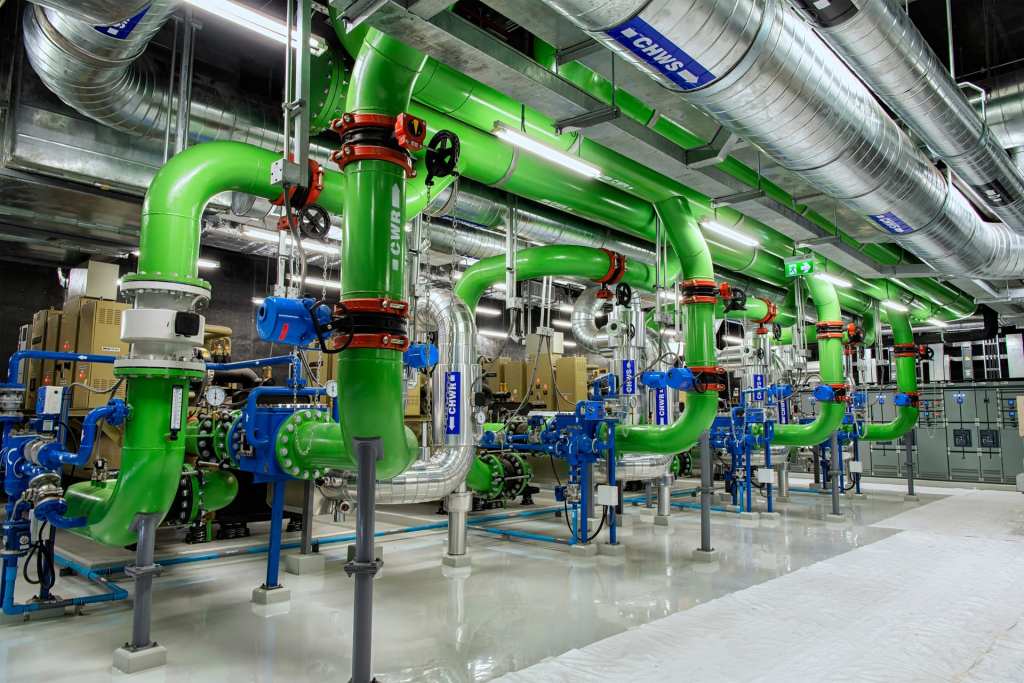Green and blue chilled water piping and valves in a central plant